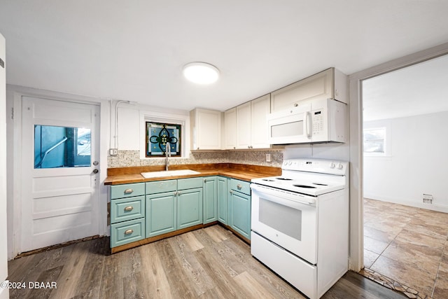 kitchen featuring butcher block counters, white cabinetry, sink, light hardwood / wood-style floors, and white appliances