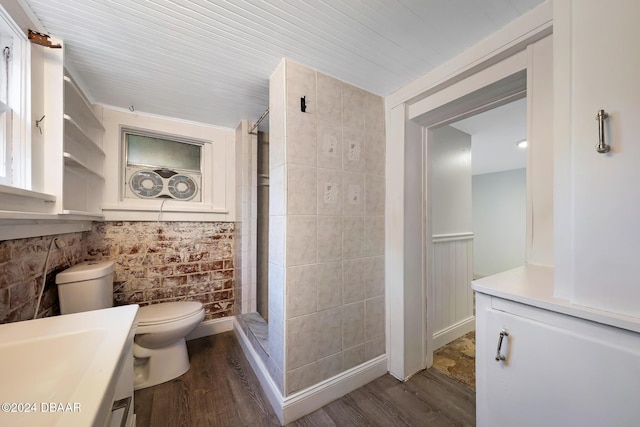 bathroom with hardwood / wood-style floors, toilet, a shower, and vanity