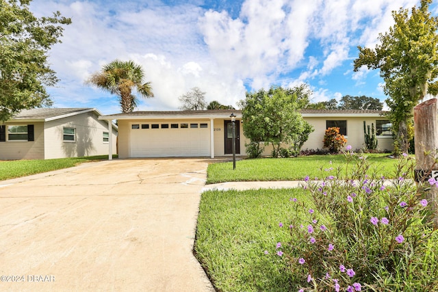 ranch-style house featuring a front yard and a garage