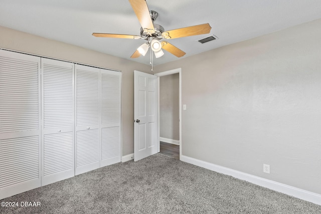 unfurnished bedroom with carpet, a closet, and ceiling fan