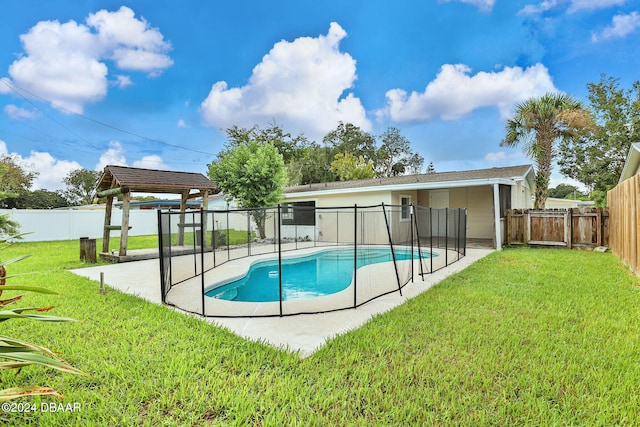 view of swimming pool with a lawn and a patio