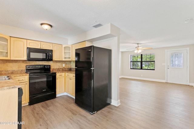 kitchen with black appliances, ceiling fan, light hardwood / wood-style floors, and decorative backsplash