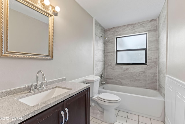 full bathroom featuring vanity, tile patterned flooring, tiled shower / bath, and toilet