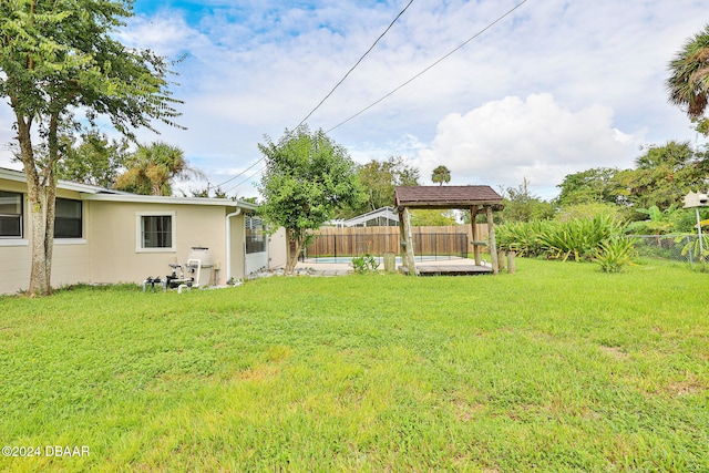 view of yard featuring a gazebo and a fenced in pool