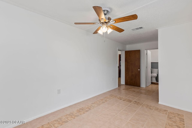 tiled spare room featuring ceiling fan, crown molding, and a textured ceiling