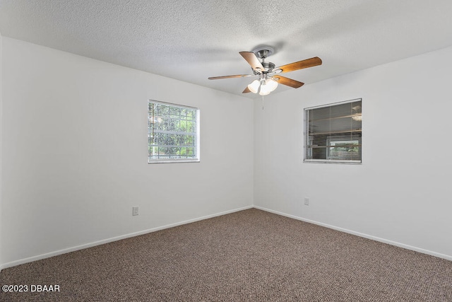 carpeted spare room featuring a textured ceiling and ceiling fan