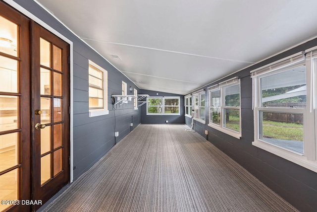 unfurnished sunroom featuring lofted ceiling