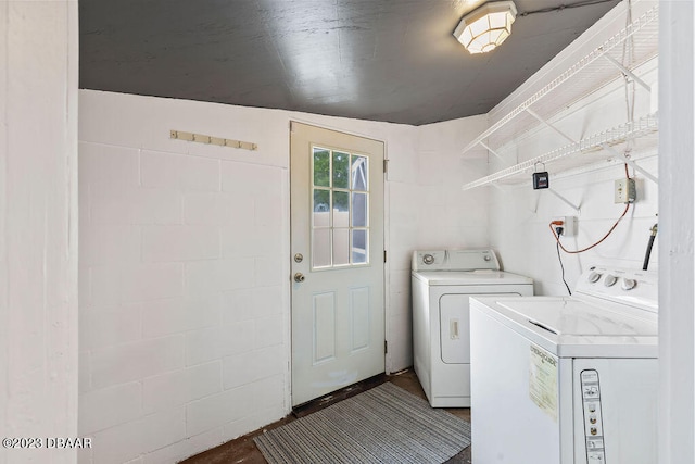 clothes washing area with washing machine and clothes dryer