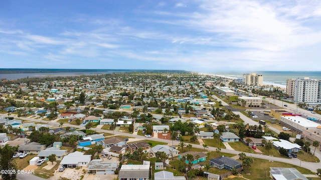 birds eye view of property with a water view and a city view