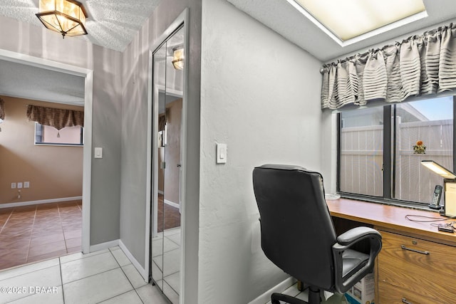 office area with light tile patterned flooring and baseboards