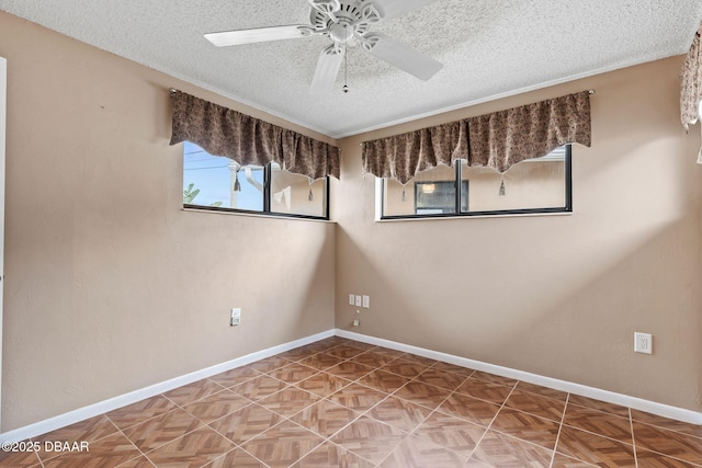 unfurnished room featuring ceiling fan, a textured ceiling, and baseboards