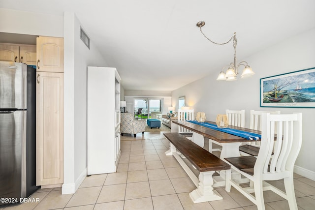 dining space with a chandelier and light tile patterned floors