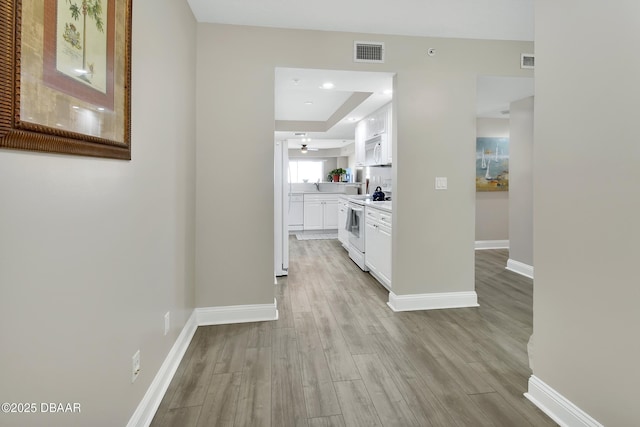 4670 Links Village Dr Unit A506, Ponce Inlet, FL 32127 - corridor featuring light wood-style flooring, visible vents, and baseboards