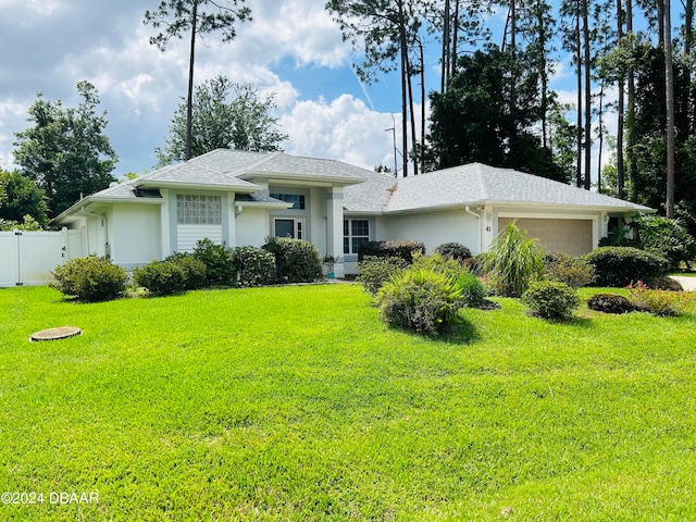 view of front of house featuring a front yard and a garage