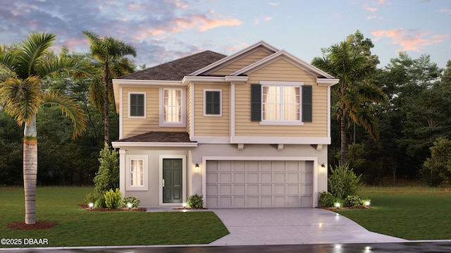 view of front of home with a lawn and a garage