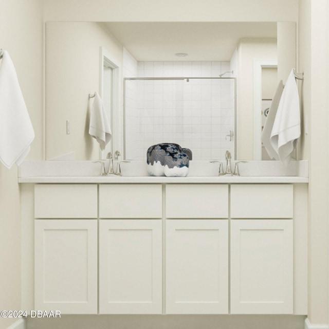 bathroom with tiled shower and vanity