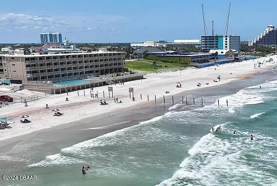 bird's eye view featuring a view of the beach and a water view