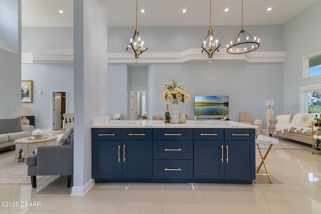 interior space featuring pendant lighting, a towering ceiling, light tile patterned flooring, and a chandelier