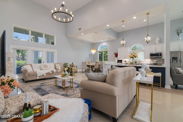 living room featuring recessed lighting, a notable chandelier, light tile patterned floors, and a towering ceiling