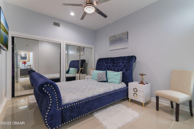 tiled bedroom with visible vents, recessed lighting, baseboards, and two closets