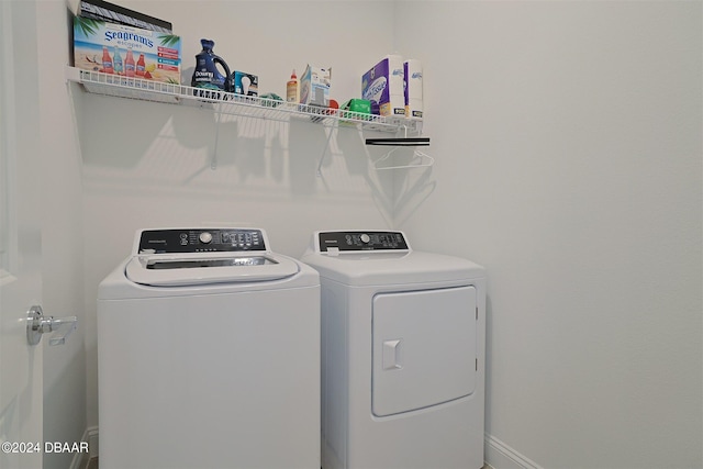 clothes washing area with separate washer and dryer