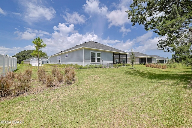 back of property featuring a yard