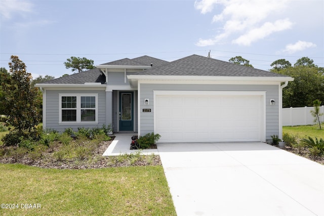 view of front of house with a garage and a front yard