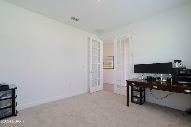 carpeted home office featuring french doors