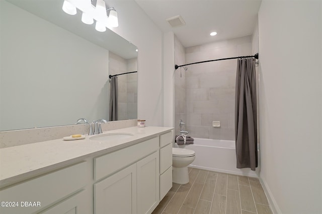 full bathroom with shower / bath combo with shower curtain, vanity, and toilet