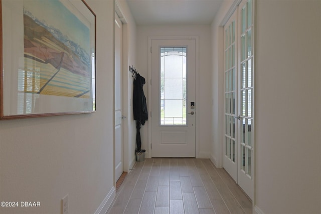 doorway with light hardwood / wood-style floors and french doors