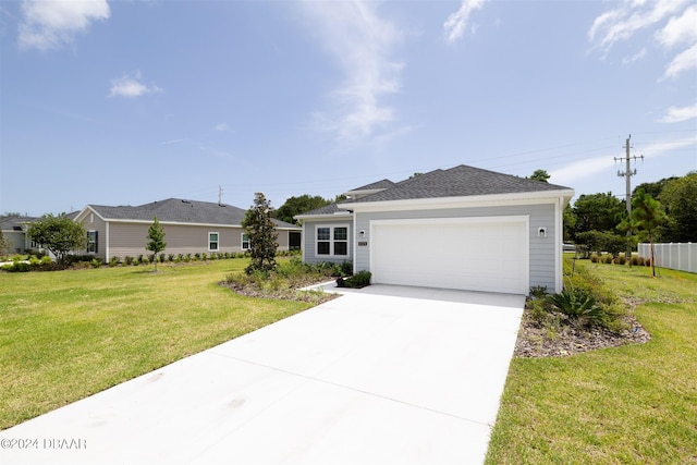 single story home with a front yard and a garage