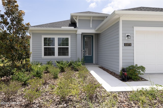 doorway to property with a garage