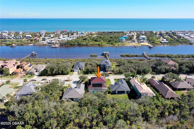 drone / aerial view with a water view and a residential view