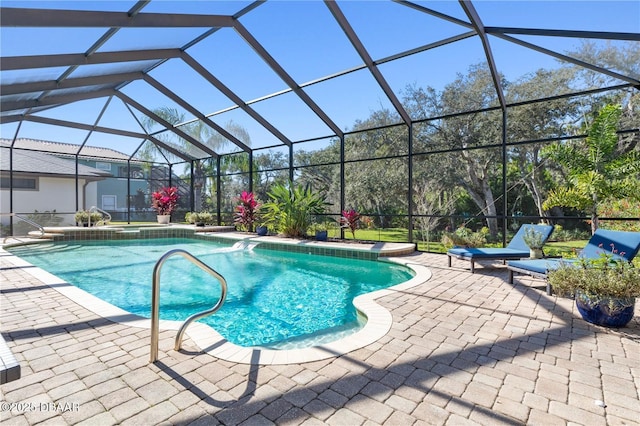 outdoor pool with glass enclosure and a patio area