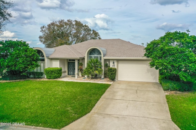 view of front of home featuring stucco siding, a shingled roof, a garage, driveway, and a front lawn