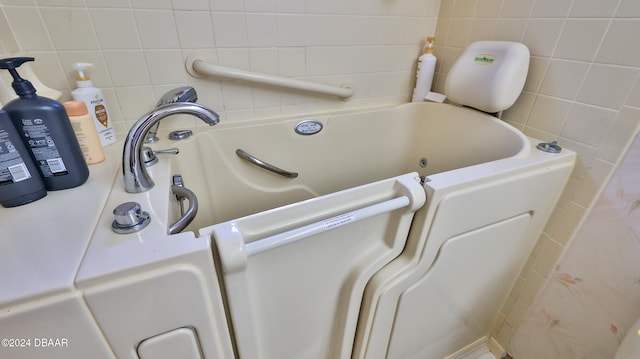 interior space featuring a bathtub and tasteful backsplash