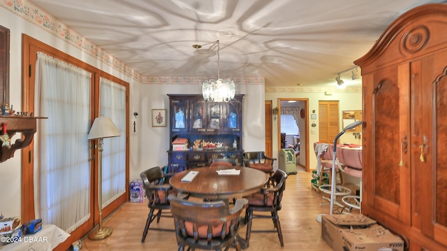 dining room featuring a chandelier and light wood-type flooring