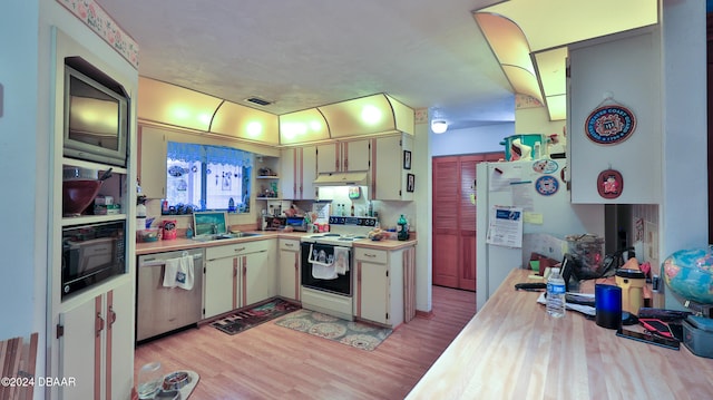 kitchen featuring light hardwood / wood-style flooring, sink, and white appliances