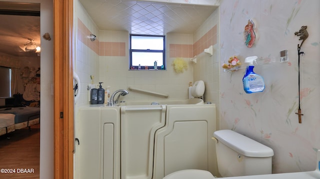 bathroom with hardwood / wood-style flooring and a tub