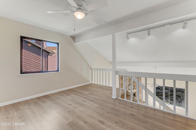 16 Wildwood Trl, Ormond Beach, FL 32174 - unfurnished room with rail lighting, ceiling fan, wood finished floors, and baseboards
