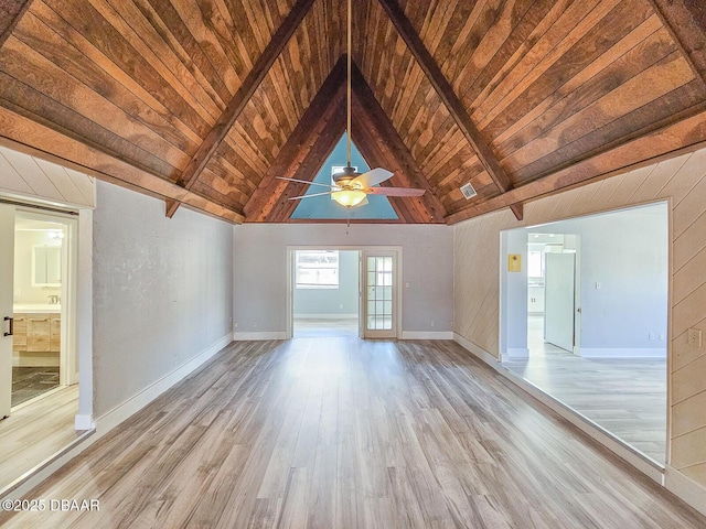 unfurnished room with ceiling fan, wooden ceiling, beamed ceiling, and light wood-type flooring