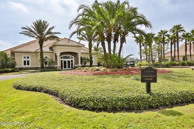 3417 Medici Blvd, New Smyrna Beach, FL 32168 - view of front of property with stucco siding, a tiled roof, and a front yard