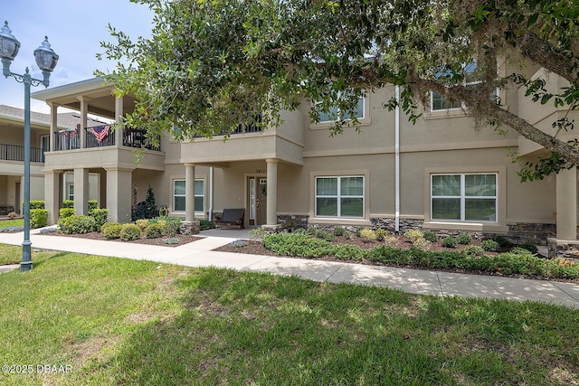 3417 Medici Blvd, New Smyrna Beach, FL 32168 - townhome / multi-family property with stone siding, stucco siding, and a front lawn