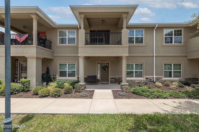 3417 Medici Blvd, New Smyrna Beach, FL 32168 - view of exterior entry featuring stucco siding and a balcony