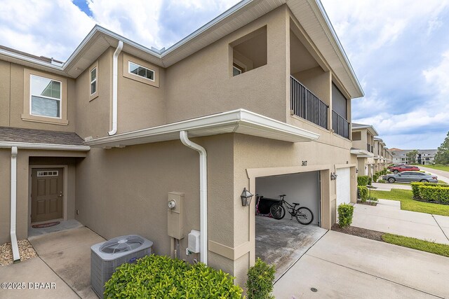 3417 Medici Blvd, New Smyrna Beach, FL 32168 - view of side of home with an attached garage, stucco siding, and driveway