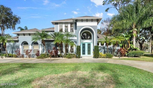 view of front of home with french doors and a front yard