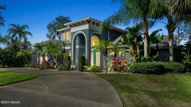 mediterranean / spanish-style home with a front yard