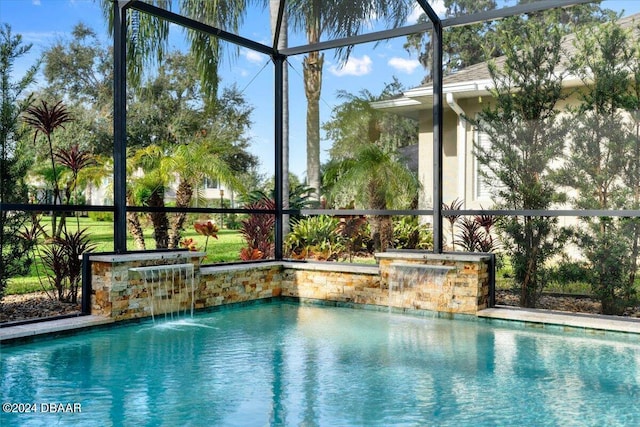 view of pool with a lanai and pool water feature