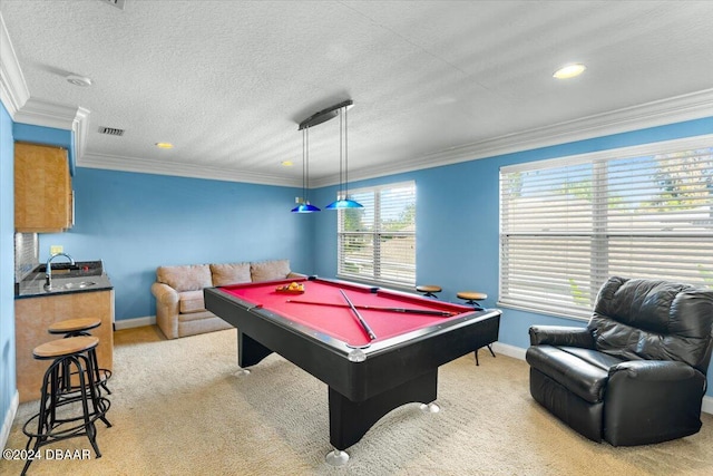 playroom featuring pool table, a textured ceiling, light carpet, sink, and ornamental molding