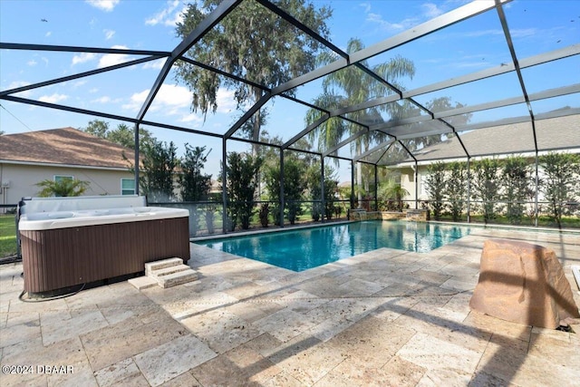 view of swimming pool featuring a lanai, a patio, and a hot tub